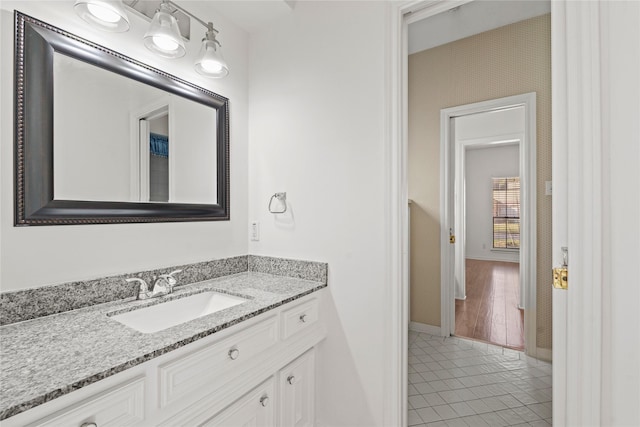 1015 Flagmore Dr, Katy, TX 77450 - bathroom with baseboards, vanity, tile patterned floors, and wallpapered walls