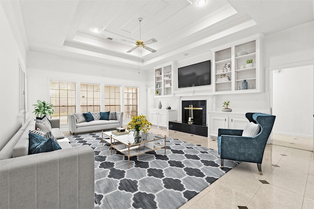 1015 Flagmore Dr, Katy, TX 77450 - living room featuring a raised ceiling, ceiling fan, a high end fireplace, light tile patterned floors, and recessed lighting