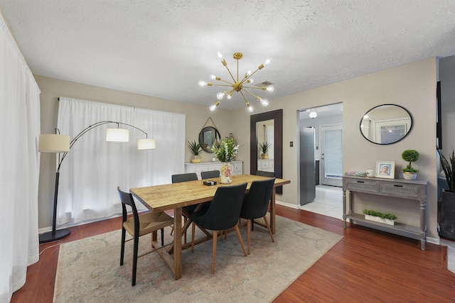8515 Cold Lake Dr, Houston, TX 77088 - dining space featuring a textured ceiling, a chandelier, and wood finished floors