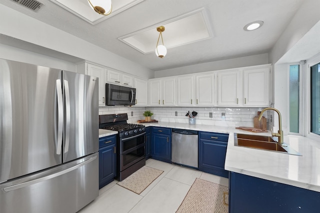 8515 Cold Lake Dr, Houston, TX 77088 - kitchen with appliances with stainless steel finishes, blue cabinets, a sink, tasteful backsplash, and light countertops