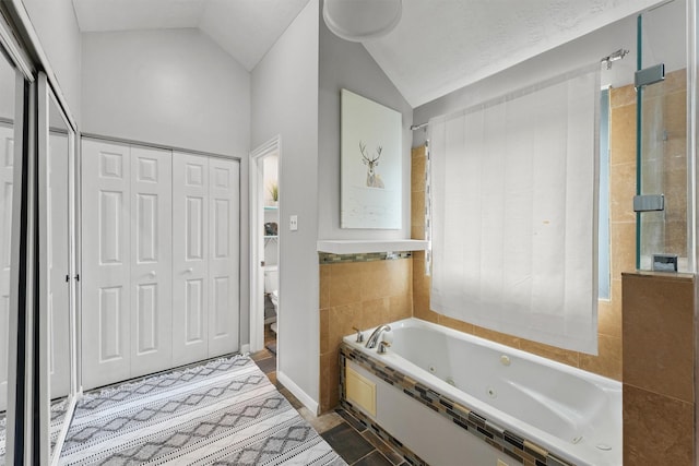 8515 Cold Lake Dr, Houston, TX 77088 - full bathroom with vaulted ceiling, a jetted tub, toilet, and a closet