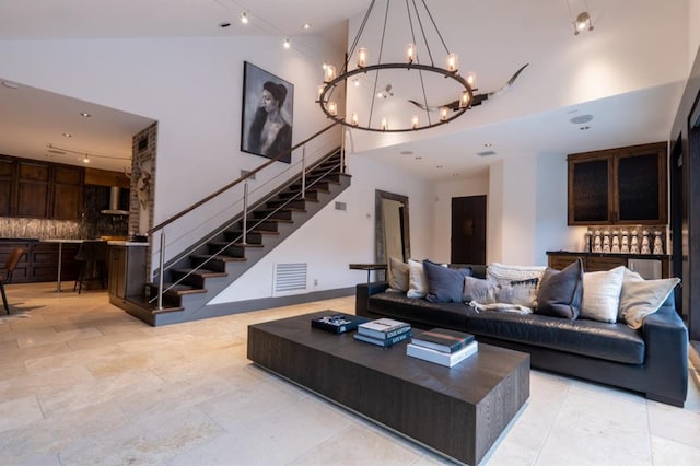 1001 Potomac Dr, Houston, TX 77057 - living room with stairs, a chandelier, a high ceiling, and recessed lighting