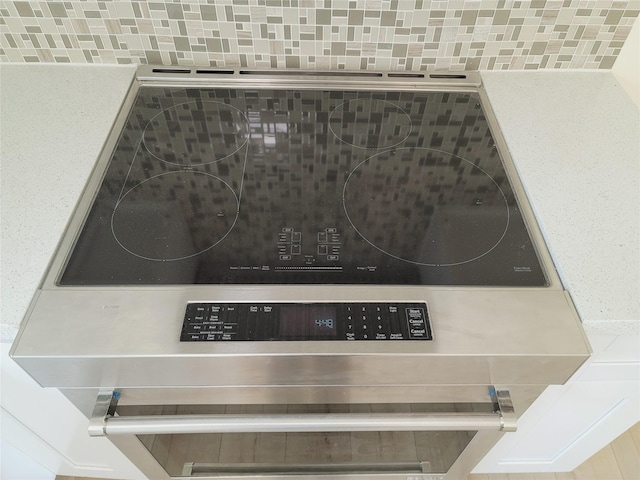 9926 Tangiers Rd, Houston, TX 77041 - kitchen view of stove and decorative backsplash