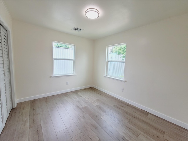 9926 Tangiers Rd, Houston, TX 77041 - unfurnished bedroom with multiple windows, light wood-style flooring, and baseboards