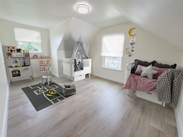 9926 Tangiers Rd, Houston, TX 77041 - recreation room featuring wood finished floors, vaulted ceiling, and baseboards