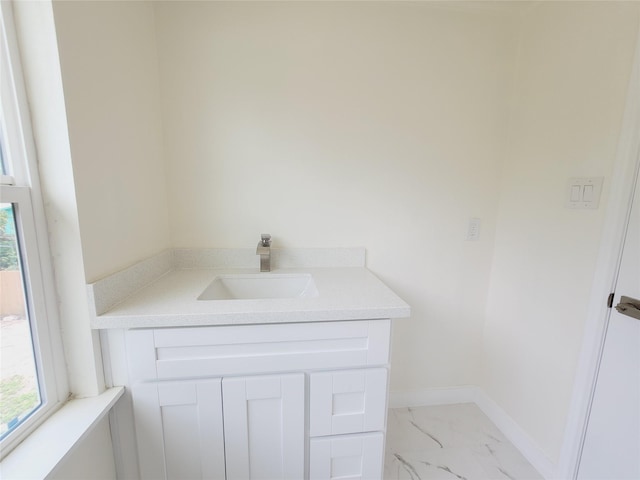 9926 Tangiers Rd, Houston, TX 77041 - bathroom featuring marble finish flooring, vanity, plenty of natural light, and baseboards