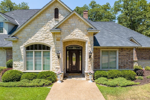 167 Saint Andrews Dr E, Mabank, TX 75156 - property entrance featuring stone siding and a chimney