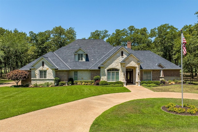 167 Saint Andrews Dr E, Mabank, TX 75156 - french country style house featuring stone siding, a front lawn, and a chimney