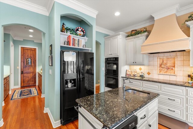 167 Saint Andrews Dr E, Mabank, TX 75156 - kitchen featuring black appliances, custom range hood, a sink, white cabinets, and recessed lighting