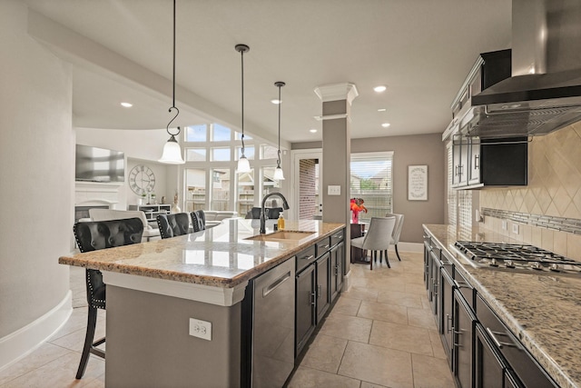 17006 Shannon Lake Ct, Houston, TX 77044 - kitchen featuring a sink, appliances with stainless steel finishes, wall chimney exhaust hood, a breakfast bar, and backsplash