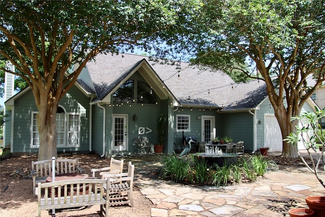 323 E County Road 461b, Brazoria, TX 77422 - rear view of house with a shingled roof and an attached garage