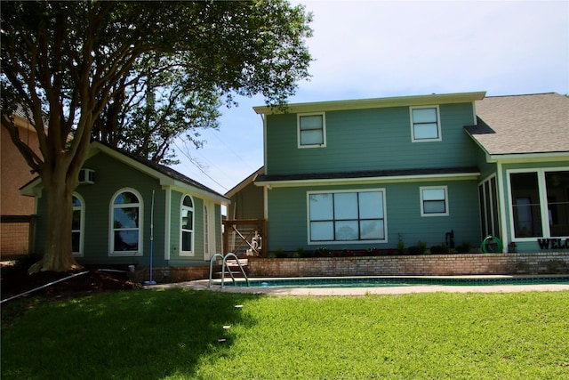 323 E County Road 461b, Brazoria, TX 77422 - rear view of house with a lawn and an outdoor pool