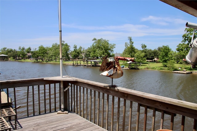 323 E County Road 461b, Brazoria, TX 77422 - wooden terrace with a water view, a boat dock, and view of wooded area