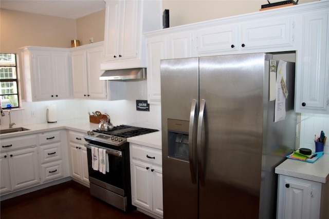 323 E County Road 461b, Brazoria, TX 77422 - kitchen with stainless steel appliances, range hood, light countertops, white cabinetry, and a sink