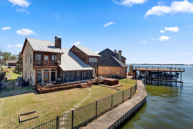 210 Hide A Way Dr, Mabank, TX 75156 - rear view of house with a standing seam roof, a chimney, metal roof, a deck with water view, and a balcony