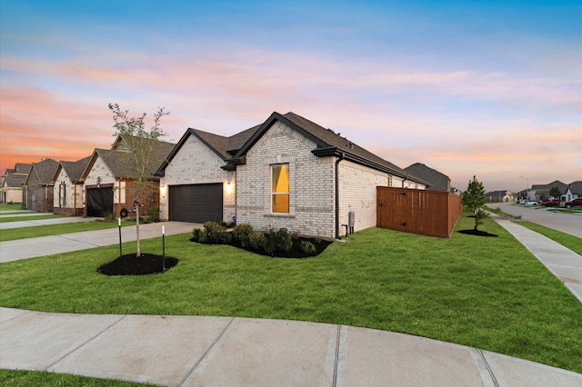 21119 Kanaka Dr, Cypress, TX 77433 - french country style house with driveway, brick siding, a yard, an attached garage, and a residential view