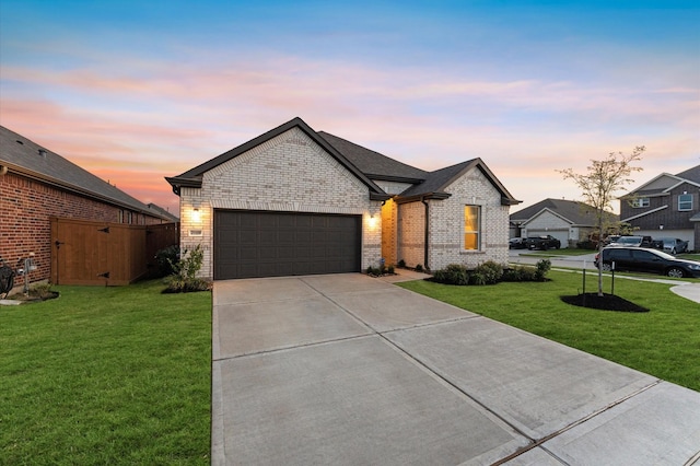 21119 Kanaka Dr, Cypress, TX 77433 - french country style house with brick siding, a yard, an attached garage, and driveway