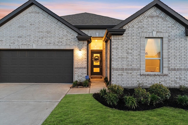 21119 Kanaka Dr, Cypress, TX 77433 - view of front of home with brick siding, a garage, concrete driveway, and a shingled roof