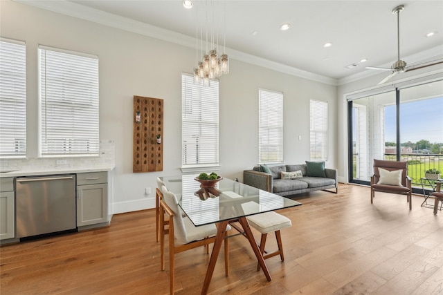 10756 Craighead Dr, Houston, TX 77025 - dining area with light wood-style floors, crown molding, recessed lighting, baseboards, and a chandelier