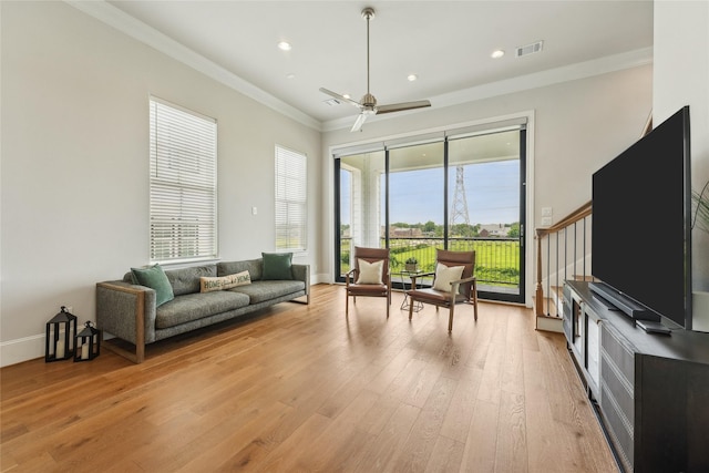 10756 Craighead Dr, Houston, TX 77025 - living area with light wood-style floors, crown molding, a ceiling fan, stairs, and baseboards