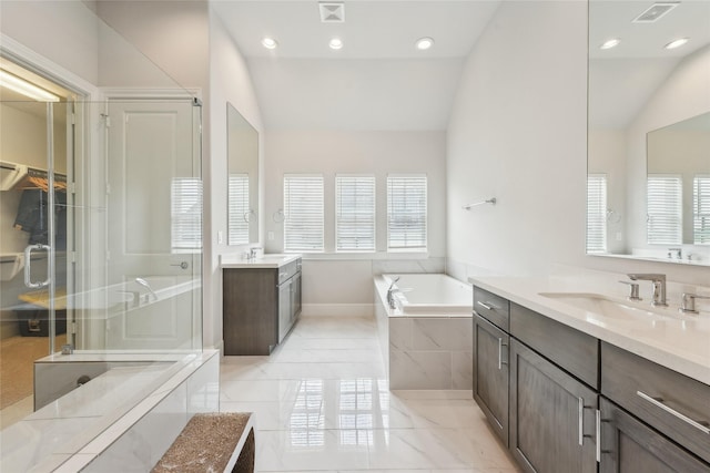10756 Craighead Dr, Houston, TX 77025 - full bathroom with lofted ceiling, a bath, two vanities, baseboards, and recessed lighting