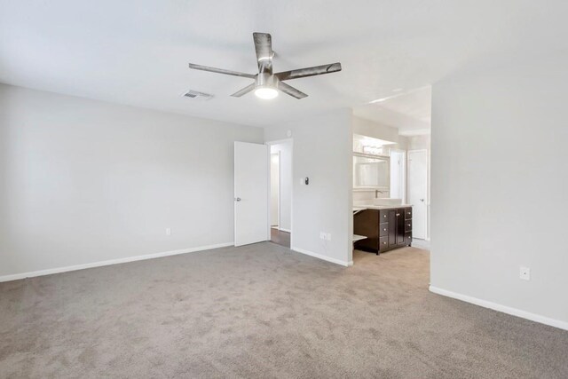 2102 Silver Moon Trl, Crosby, TX 77532 - unfurnished bedroom with light carpet, baseboards, ensuite bath, and a ceiling fan