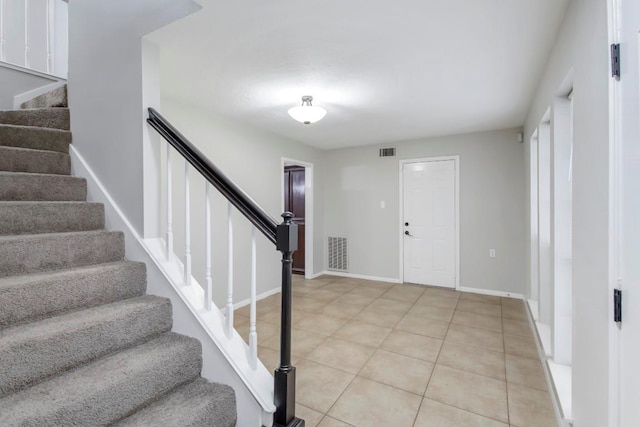 2102 Silver Moon Trl, Crosby, TX 77532 - foyer entrance with stairway, light tile patterned floors, and baseboards