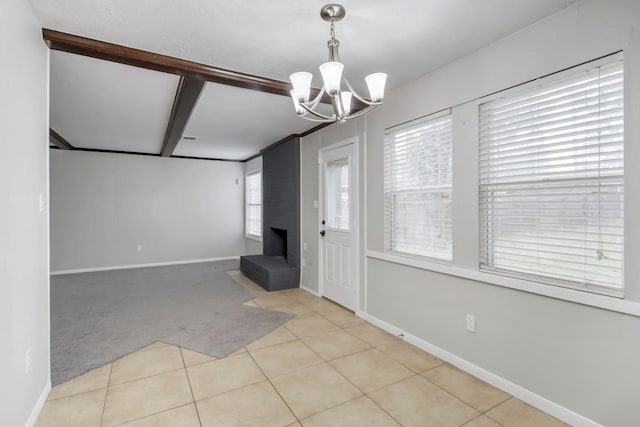 2102 Silver Moon Trl, Crosby, TX 77532 - carpeted foyer with a chandelier, a brick fireplace, tile patterned flooring, and baseboards