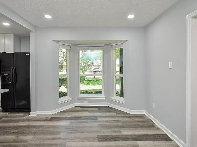 1919 Fall Meadow Dr, Missouri City, TX 77459 - unfurnished dining area with wood finished floors, baseboards, recessed lighting, and a textured ceiling