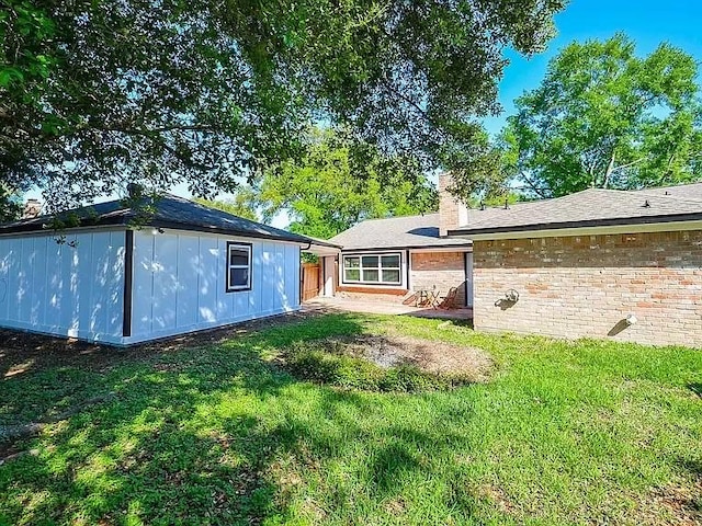 1919 Fall Meadow Dr, Missouri City, TX 77459 - back of property featuring a yard, a chimney, and brick siding