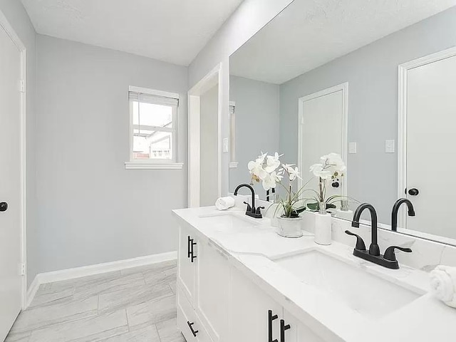 1919 Fall Meadow Dr, Missouri City, TX 77459 - bathroom featuring marble finish flooring, double vanity, and baseboards