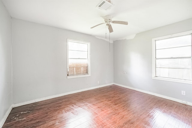 606 Roosevelt St, La Marque, TX 77568 - spare room featuring plenty of natural light, wood finished floors, and baseboards