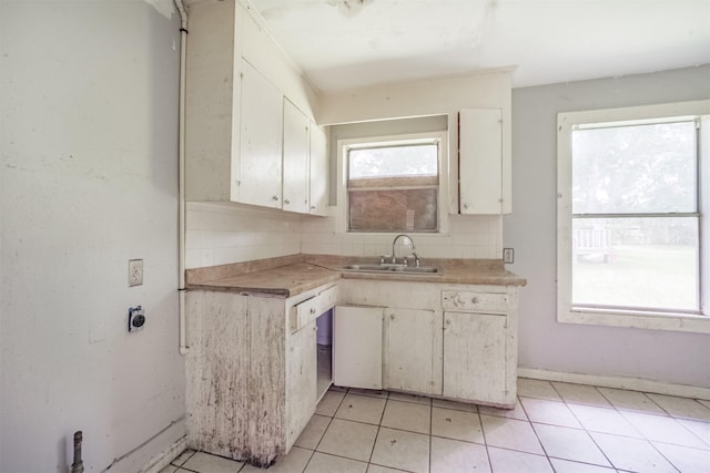 606 Roosevelt St, La Marque, TX 77568 - kitchen featuring a sink, light countertops, decorative backsplash, and white cabinets