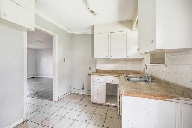 606 Roosevelt St, La Marque, TX 77568 - kitchen featuring white cabinetry, a sink, light countertops, and light tile patterned floors