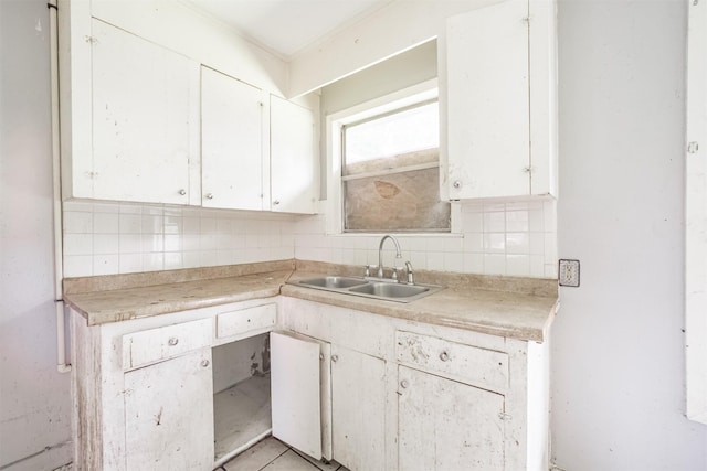 606 Roosevelt St, La Marque, TX 77568 - kitchen featuring a sink, decorative backsplash, and light countertops