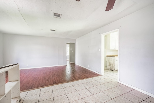 606 Roosevelt St, La Marque, TX 77568 - spare room with ceiling fan, light tile patterned floors, and baseboards