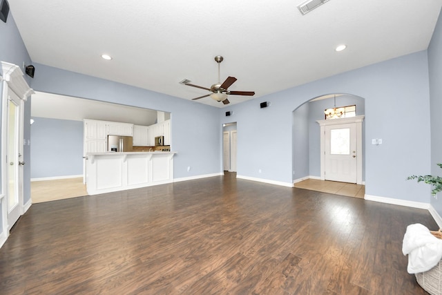 105 Meadowlark Ct, Richwood, TX 77566 - unfurnished living room with arched walkways, a ceiling fan, wood finished floors, baseboards, and recessed lighting