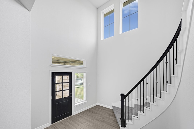 24634 Carleton Lake Ln, Tomball, TX 77375 - entrance foyer with a high ceiling, stairs, baseboards, and wood finished floors