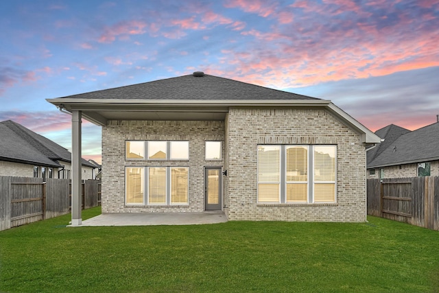 24634 Carleton Lake Ln, Tomball, TX 77375 - back of property at dusk featuring brick siding and a patio area