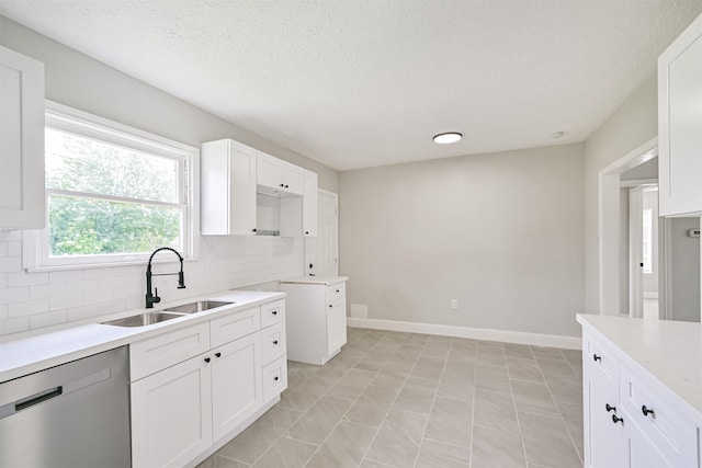 5007 Northridge Dr, Houston, TX 77033 - kitchen with dishwasher, a sink, decorative backsplash, white cabinets, and a textured ceiling