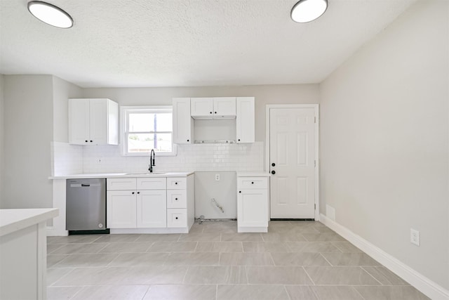5007 Northridge Dr, Houston, TX 77033 - kitchen featuring stainless steel dishwasher, a sink, tasteful backsplash, white cabinets, and baseboards