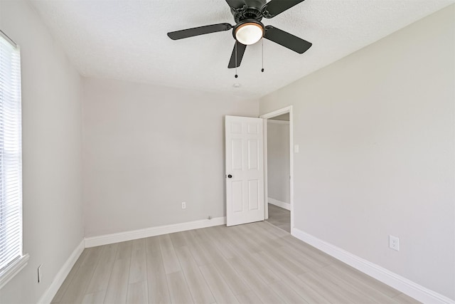 5007 Northridge Dr, Houston, TX 77033 - unfurnished room with light wood-style flooring, plenty of natural light, ceiling fan, a textured ceiling, and baseboards