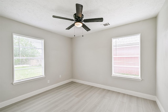 5007 Northridge Dr, Houston, TX 77033 - unfurnished room featuring baseboards, light wood-style floors, a textured ceiling, and ceiling fan