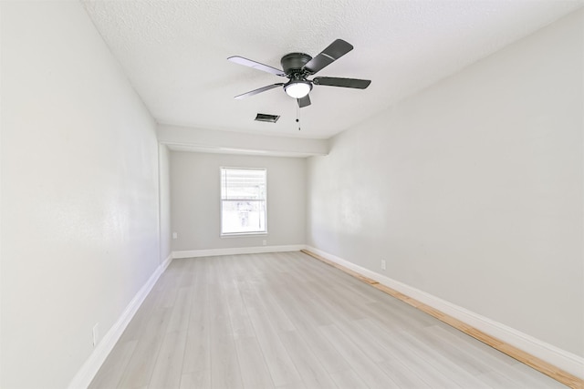 5007 Northridge Dr, Houston, TX 77033 - unfurnished room with light wood-style flooring, a ceiling fan, baseboards, and a textured ceiling