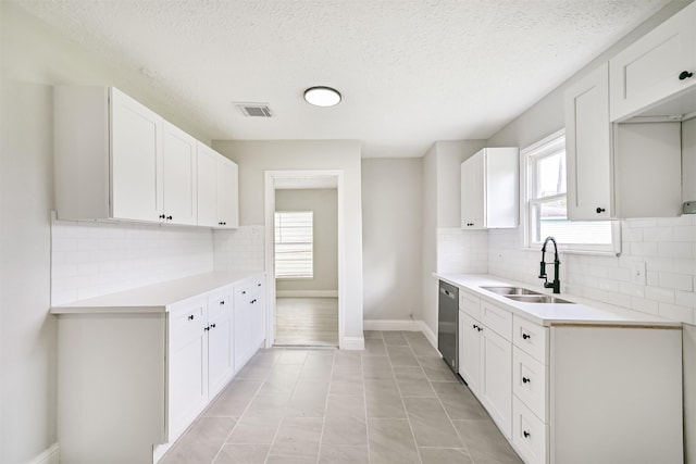 5007 Northridge Dr, Houston, TX 77033 - kitchen featuring a sink, dishwasher, tasteful backsplash, light countertops, and a textured ceiling
