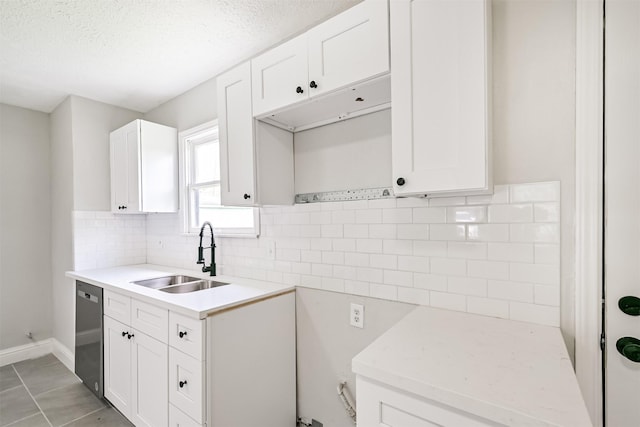 5007 Northridge Dr, Houston, TX 77033 - kitchen with a sink, stainless steel dishwasher, light countertops, tasteful backsplash, and a textured ceiling