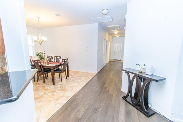 15102 Dry Ridge Ct, Humble, TX 77346 - dining area with light wood finished floors, a chandelier, and baseboards