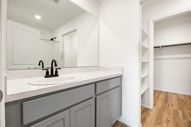 4307 Palmetto Grove Ln, Baytown, TX 77521 - full bath featuring vanity, a spacious closet, wood finished floors, a shower, and baseboards