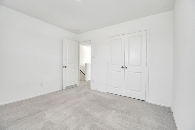 4307 Palmetto Grove Ln, Baytown, TX 77521 - unfurnished bedroom featuring light carpet, baseboards, and a closet