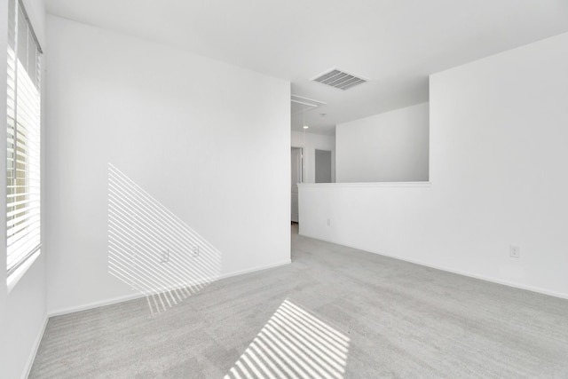 4307 Palmetto Grove Ln, Baytown, TX 77521 - empty room featuring carpet, attic access, healthy amount of natural light, and baseboards